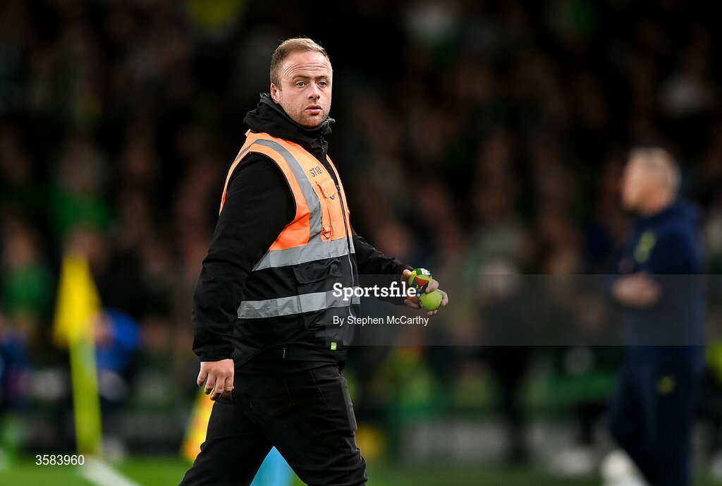 1 October 2026; A member of security removes tennis balls which were thrown onto the pitch in protest  during the UEFA Nations League B match between the Republic of Ireland and Austria at the Aviva Stadium in Dublin. Photo by Stephen McCarthy/Sportsfile