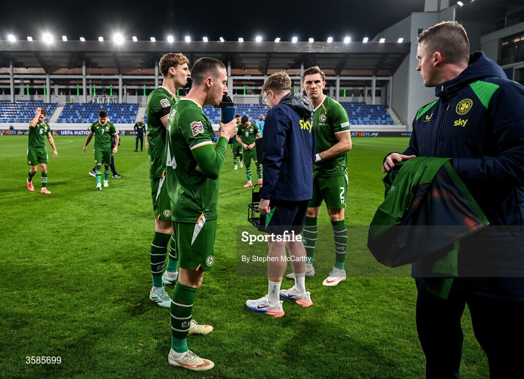 4 October 2026; Jack Moylan of Republic of Ireland takes a drink as communications manager Kieran Crowley reminds the players not to pose for their traditional team photograph before the UEFA Nations League B match between the Republic of Ireland and Israel at TSC Arena in Backa Topola, Serbia. Photo by Stephen McCarthy/Sportsfile