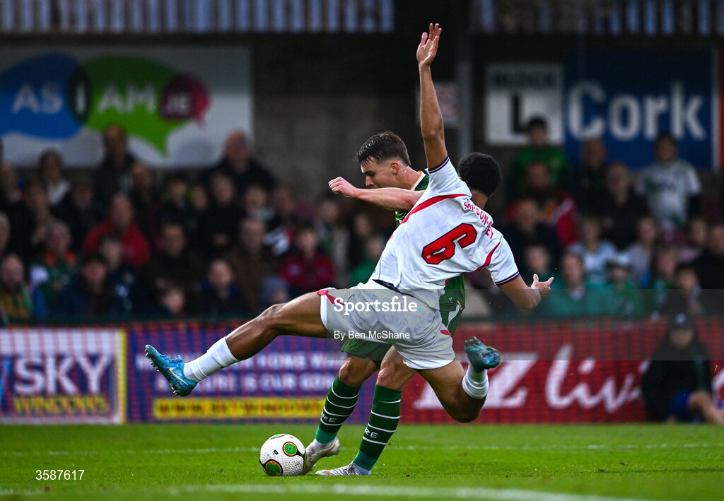 6 October 2026; Tommy Lonergan of Republic of Ireland scores his side's first goal despite the tackle of Jahmai Simpson-Pusey of England during the UEFA European U21 Championship qualifier match between the Republic of Ireland and England at Turner's Cross Stadium in Cork. Photo by Ben McShane/Sportsfile