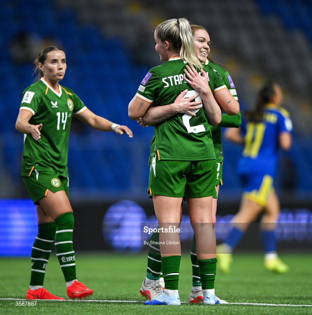 9 October 2026; Jessie Stapleton of Republic of Ireland, 2, celebrates with team-mates Aoife Mannion, right, and Shanade Hopcroft after scoring their side's eighth goal during the 2027 FIFA Women’s World Cup qualifying round 1 play-off first leg match between Kazakhstan and the Republic of Ireland at Astana Arena in Kazakhstan. Photo by Shauna Clinton/Sportsfile