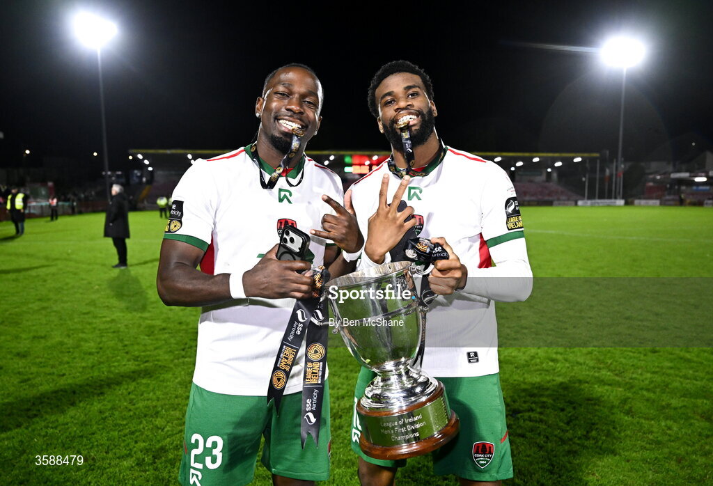 9 October 2026; Chris N'sa, left, and Hans Mpongo of Cork City celebrate with the SSE Airtricity Men’s First Division trophy after the SSE Airtricity Men’s First Division match between Cork City and Finn Harps at Turner's Cross in Cork. Photo by Ben McShane/Sportsfile