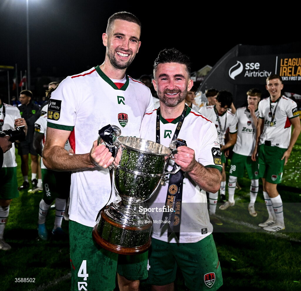 9 October 2026; Cork City captain Fiacre Kelleher, left, and teammate Seani Maguire celebrate with the SSE Airtricity Men’s First Division trophy after the SSE Airtricity Men’s First Division match between Cork City and Finn Harps at Turner's Cross in Cork. Photo by Ben McShane/Sportsfile