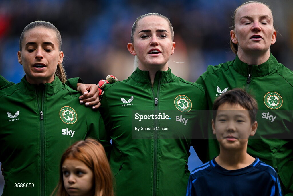 9 October 2026; Republic of Ireland players, from left, Chloe Mustaki, Jessie Stapleton and Courtney Brosnan stand for the playing of the national anthem before the 2027 FIFA Women’s World Cup qualifying round 1 play-off first leg match between Kazakhstan and the Republic of Ireland at Astana Arena in Kazakhstan. Photo by Shauna Clinton/Sportsfile