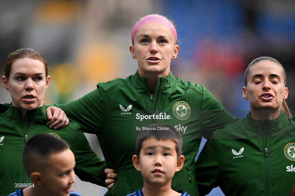 9 October 2026; Republic of Ireland players, from left, Aoife Mannion, Caitlin Hayes and Chloe Mustaki stand for the playing of the national anthem before the 2027 FIFA Women’s World Cup qualifying round 1 play-off first leg match between Kazakhstan and the Republic of Ireland at Astana Arena in Kazakhstan. Photo by Shauna Clinton/Sportsfile