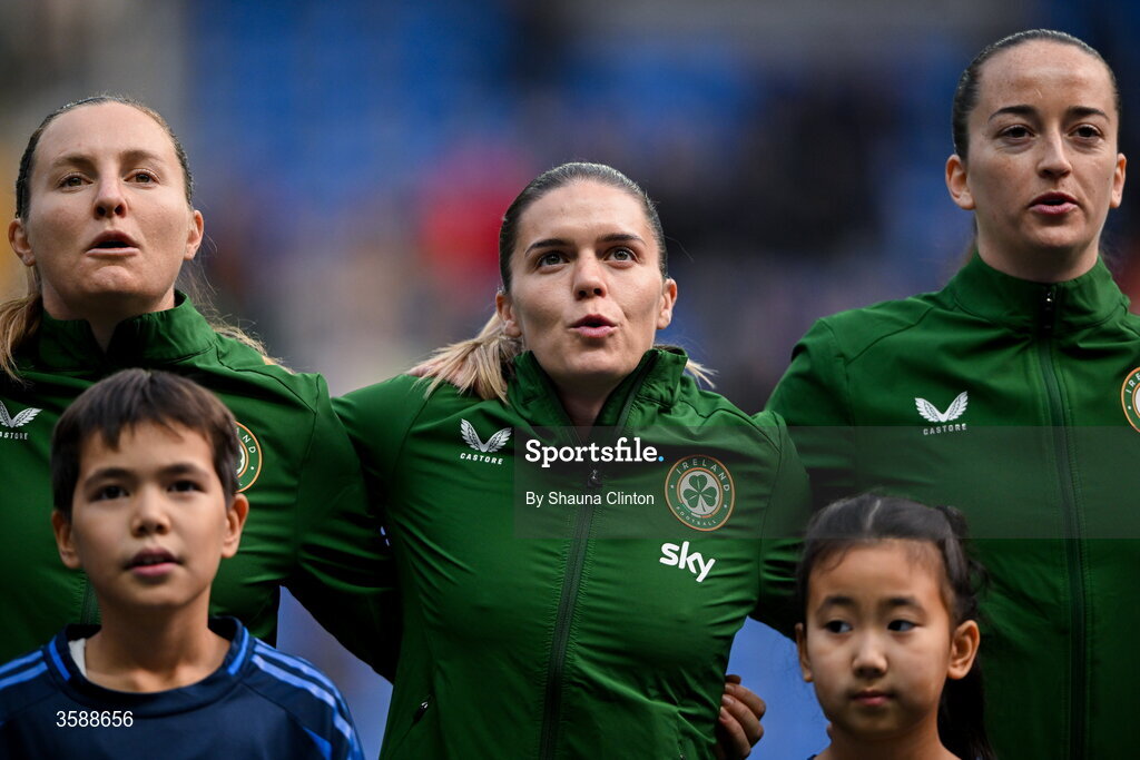 9 October 2026; Republic of Ireland players, from left, Kyra Carusa, Jamie Finn and Anna Patten stand for the playing of the national anthem before the 2027 FIFA Women’s World Cup qualifying round 1 play-off first leg match between Kazakhstan and the Republic of Ireland at Astana Arena in Kazakhstan. Photo by Shauna Clinton/Sportsfile