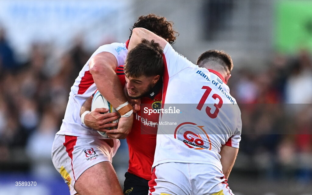 10 October 2026; Alex Nankivell of Munster is tackled by Dave McCann, left, and Jamie Benson of Ulster during the United Rugby Championship match between Ulster and Munster at Affidea Stadium in Belfast. Photo by Ben McShane/Sportsfile