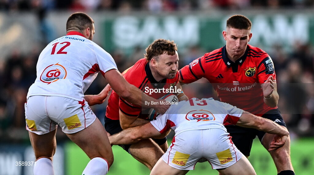 10 October 2026; Alex Nankivell of Munster is tackled by Stuart McCloskey, left, and Jamie Benson of Ulster during the United Rugby Championship match between Ulster and Munster at Affidea Stadium in Belfast. Photo by Ben McShane/Sportsfile