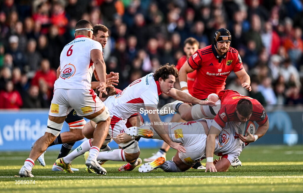 10 October 2026; Jack O'Donoghue of Munster is tackled by Ben Donnell, centre, and Dave McCann of Ulster during the United Rugby Championship match between Ulster and Munster at Affidea Stadium in Belfast. Photo by Ben McShane/Sportsfile