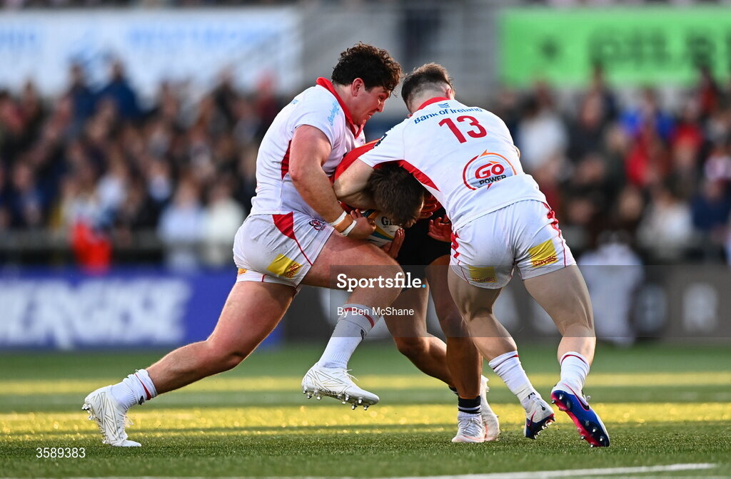10 October 2026; Alex Nankivell of Munster is tackled by Dave McCann, left, and Jamie Benson of Ulster during the United Rugby Championship match between Ulster and Munster at Affidea Stadium in Belfast. Photo by Ben McShane/Sportsfile