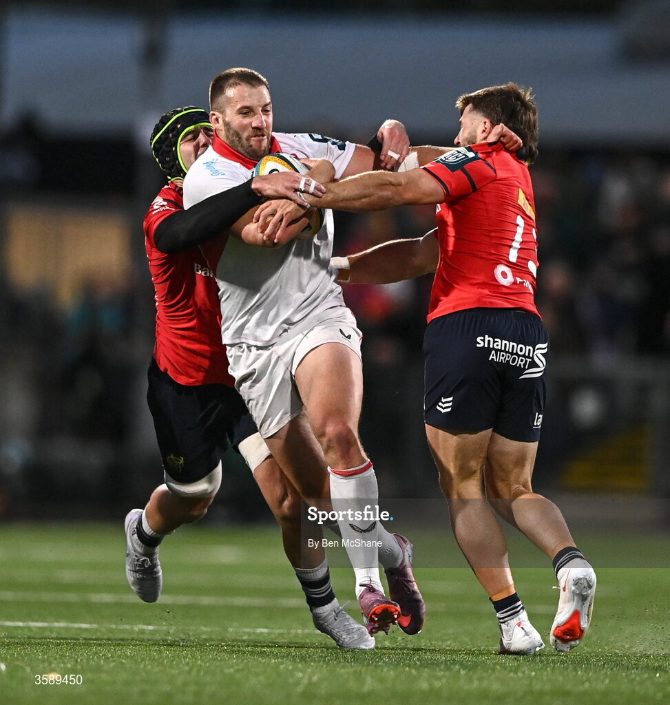 10 October 2026; Stuart McCloskey of Ulster is tackled by Alex Kendellen, left, and Alex Nankivell of Munster during the United Rugby Championship match between Ulster and Munster at Affidea Stadium in Belfast. Photo by Ben McShane/Sportsfile