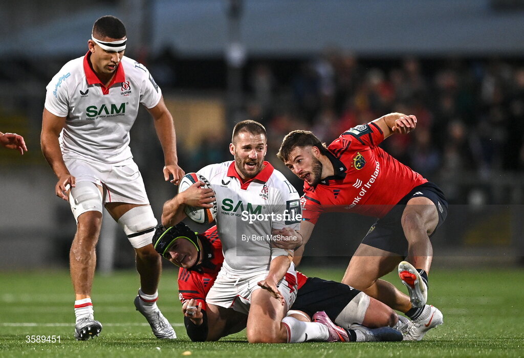 10 October 2026; Stuart McCloskey of Ulster is tackled by Alex Kendellen, left, and Alex Nankivell of Munster during the United Rugby Championship match between Ulster and Munster at Affidea Stadium in Belfast. Photo by Ben McShane/Sportsfile