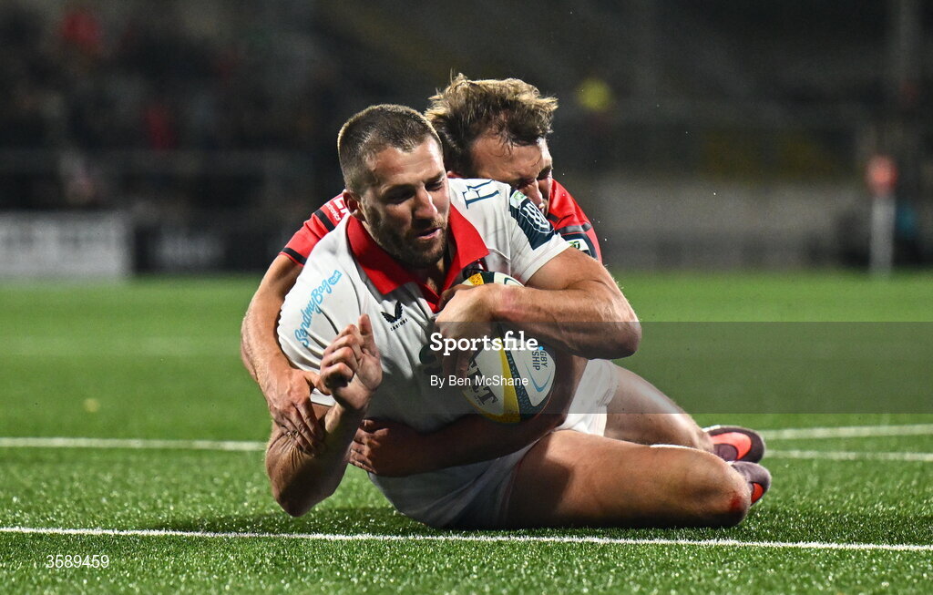 10 October 2026; Stuart McCloskey of Ulster runs in to score his side's fourth try despite the tackle of Max Clein of Munster during the United Rugby Championship match between Ulster and Munster at Affidea Stadium in Belfast. Photo by Ben McShane/Sportsfile