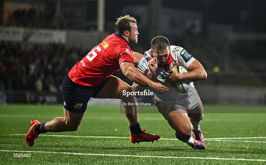 10 October 2026; Stuart McCloskey of Ulster runs in to score his side's fourth try despite the tackle of Max Clein of Munster during the United Rugby Championship match between Ulster and Munster at Affidea Stadium in Belfast. Photo by Ben McShane/Sportsfile