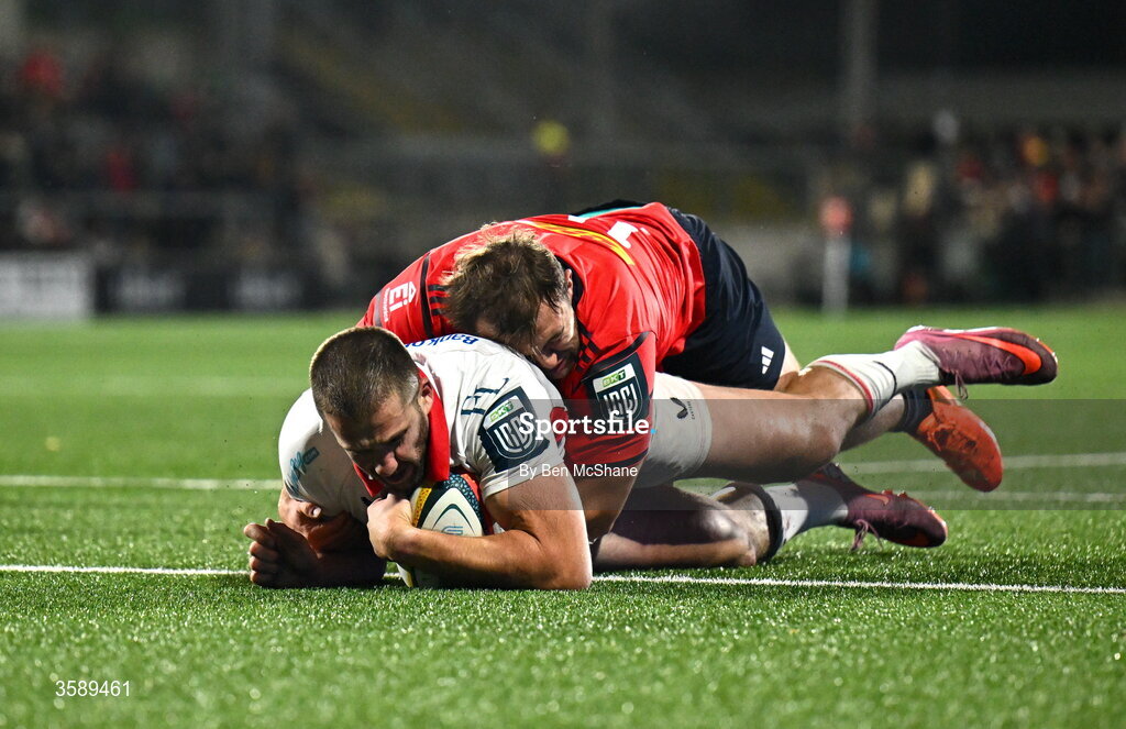 10 October 2026; Stuart McCloskey of Ulster scores his side's fourth try despite the tackle of Max Clein of Munster during the United Rugby Championship match between Ulster and Munster at Affidea Stadium in Belfast. Photo by Ben McShane/Sportsfile