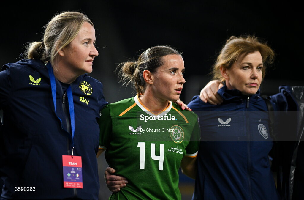 9 October 2026; Republic of Ireland equipment manager Ciara Ennis, left, and team doctor Siobhán Forman, right, with Shanade Hopcroft of Republic of Ireland the 2027 FIFA Women’s World Cup qualifying round 1 play-off first leg match between Kazakhstan and the Republic of Ireland at Astana Arena in Kazakhstan. Photo by Shauna Clinton/Sportsfile