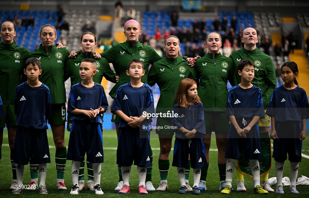9 October 2026; Republic of Ireland players, from left, Anna Patten, Megan Connolly, Aoife Mannion, Caitlin Hayes, Chloe Mustaki, Jessie Stapleton and Courtney Brosnan stand with mascots for the playing of the national anthems before the 2027 FIFA Women’s World Cup qualifying round 1 play-off first leg match between Kazakhstan and the Republic of Ireland at Astana Arena in Kazakhstan. Photo by Shauna Clinton/Sportsfile
