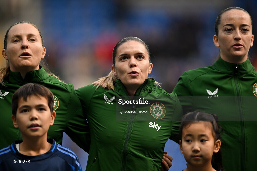 9 October 2026; Republic of Ireland players, from left, Kyra Carusa, Jamie Finn and Anna Patten stand for the playing of the national anthem before the 2027 FIFA Women’s World Cup qualifying round 1 play-off first leg match between Kazakhstan and the Republic of Ireland at Astana Arena in Kazakhstan. Photo by Shauna Clinton/Sportsfile