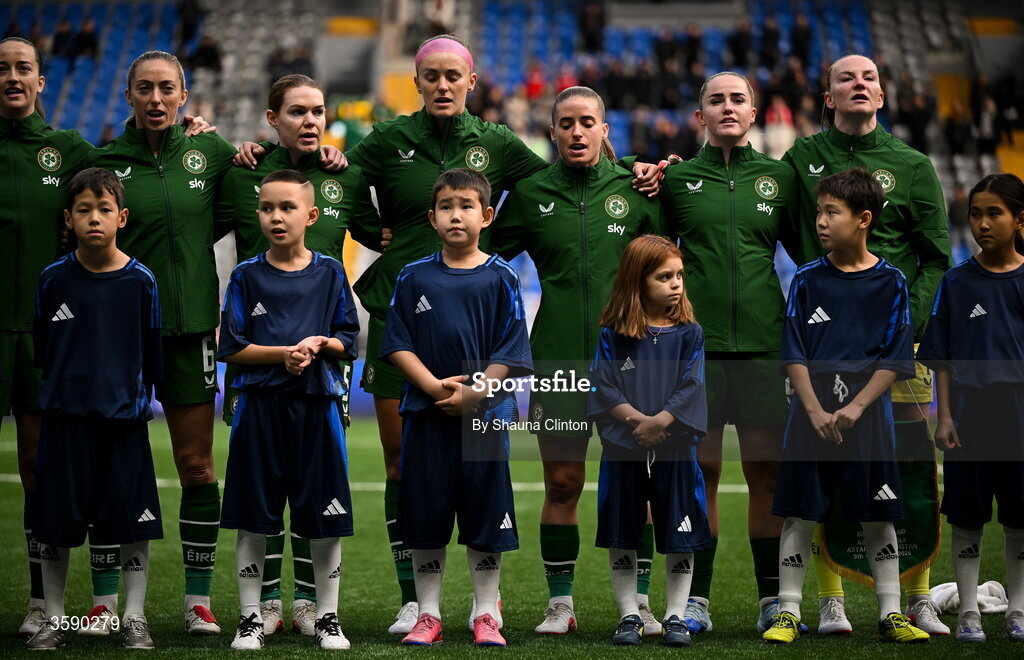 9 October 2026; Republic of Ireland players, from left, Anna Patten, Megan Connolly, Aoife Mannion, Caitlin Hayes, Chloe Mustaki, Jessie Stapleton and Courtney Brosnan stand with mascots for the playing of the national anthems before the 2027 FIFA Women’s World Cup qualifying round 1 play-off first leg match between Kazakhstan and the Republic of Ireland at Astana Arena in Kazakhstan. Photo by Shauna Clinton/Sportsfile