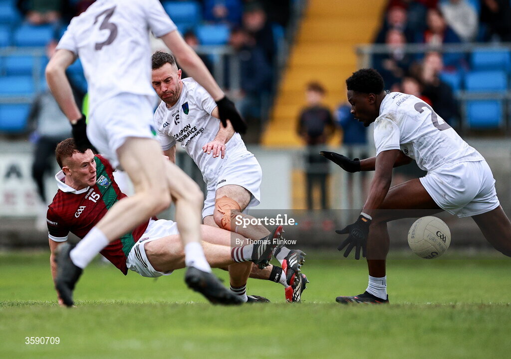 11 October 2026; Colm Murphy of Portarlington on his way to scoring his side's first goal despite the attention of Collins Ugochukwu of Courtwood, right, during the Laois County Senior Club Football Championship final match between Courtwood and Portarlington at Laois Hire O'Moore Park in Portlaoise, Laois. Photo by Thomas Flinkow/Sportsfile