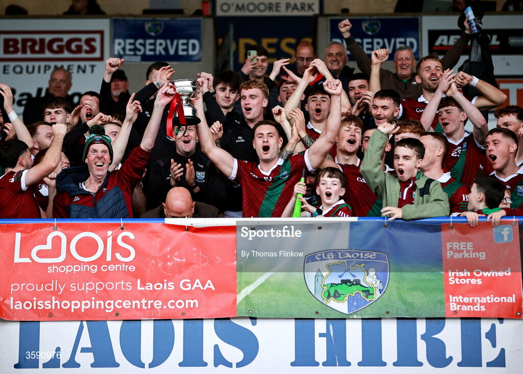 11 October 2026; Portarlington captain Patrick O Sullivan lifts the cup with supporter Terry Lawlor after the Laois County Senior Club Football Championship final match between Courtwood and Portarlington at Laois Hire O'Moore Park in Portlaoise, Laois. Photo by Thomas Flinkow/Sportsfile