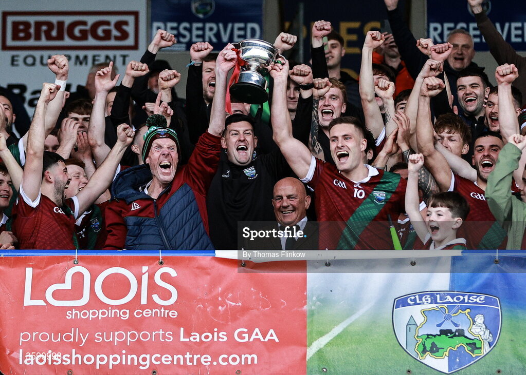 11 October 2026; Portarlington captain Patrick O Sullivan lifts the cup with supporter Terry Lawlor after the Laois County Senior Club Football Championship final match between Courtwood and Portarlington at Laois Hire O'Moore Park in Portlaoise, Laois. Photo by Thomas Flinkow/Sportsfile