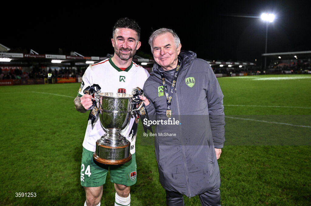 9 October 2026; Seani Maguire of Cork City, left, and Cork city team doctor Dr Gerard Murphy and the SSE Airtrity Men's First Division trophy after the SSE Airtricity Men’s First Division match between Cork City and Finn Harps at Turner's Cross in Cork. Photo by Ben McShane/Sportsfile