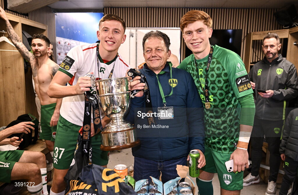 9 October 2026; Luke Downey, left, groundsman Barry Moore and Cork City goalkeeper Shane Hallihan with the SSE Airtrity Men's First Division trophy after the SSE Airtricity Men’s First Division match between Cork City and Finn Harps at Turner's Cross in Cork. Photo by Ben McShane/Sportsfile
