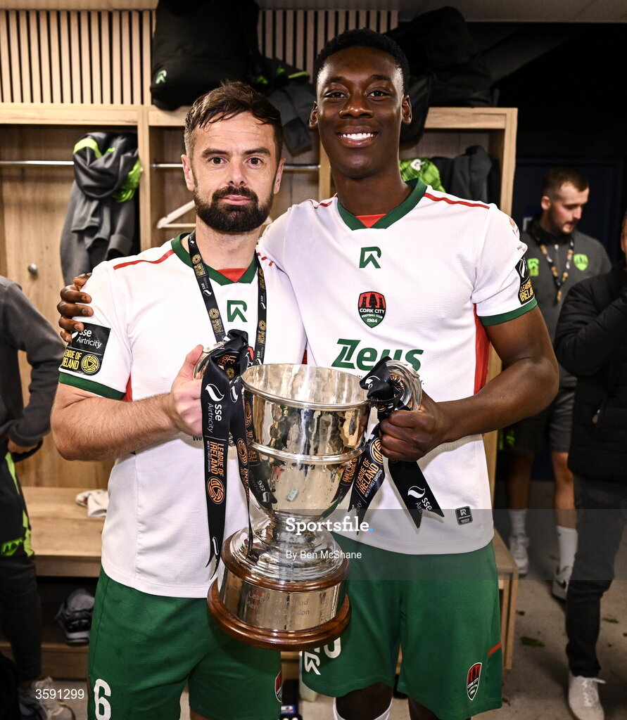 9 October 2026; Greg Bolger, left, and Denzell Obenge of Cork City with the SSE Airtrity Men's First Division trophy after the SSE Airtricity Men’s First Division match between Cork City and Finn Harps at Turner's Cross in Cork. Photo by Ben McShane/Sportsfile