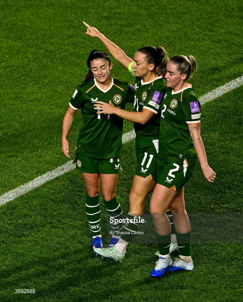 13 October 2026; Katie McCabe of Republic of Ireland, centre, celebrates with teammate Marissa Sheva, left, and Jessie Stapleton after scoring their their second goal during the 2027 FIFA Women’s World Cup qualifying round 1 play-off second leg match between the Republic of Ireland and Kazakhstan at Páirc Uí Chaoimh in Cork. Photo by Shauna Clinton/Sportsfile