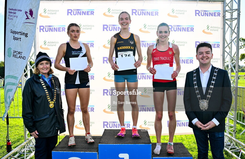 18 October 2026; U20 Women 4500m top three finishers, Megan Brunt of Blackrock AC, Dublin, centre, first, Emma Hickey of United Striders AC, left, second, and Claire O’Grady of Ennis Track AC, right, third, alongside Athletics Ireland President Brid Golden and Deputy Mayor of Fingal Luke Corkery during the Autumn Open Cross Country International at the Sport Ireland Campus in Dublin. Photo by Sam Barnes/Sportsfile