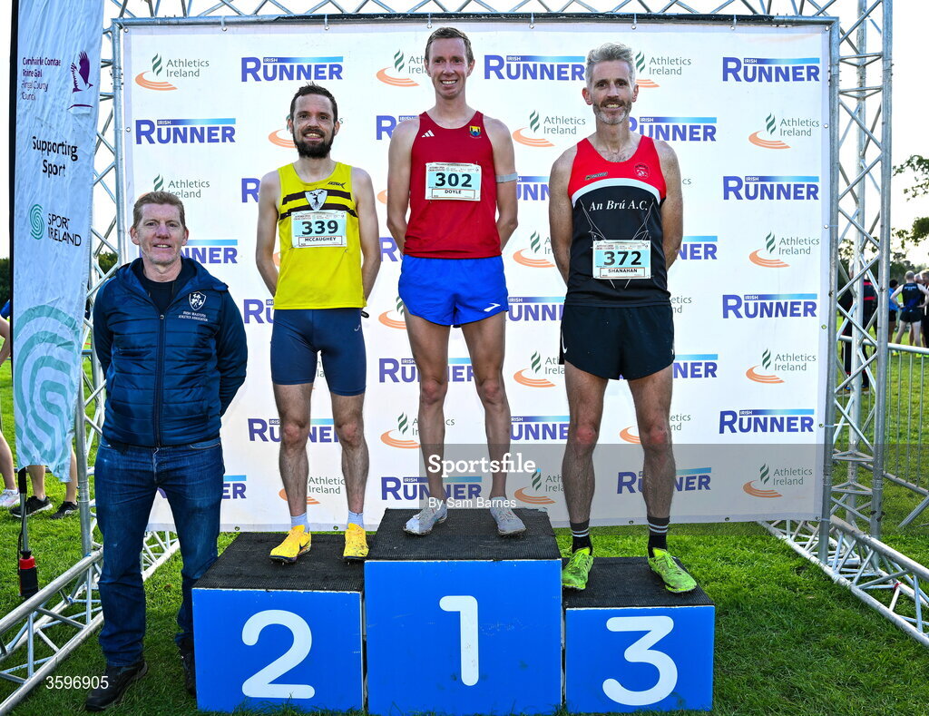 18 October 2026; Irish Masters Athletics Association President Ronan Gately with Master Men 7500m top 3 finishers, Sean Doyle of Cork City AC, centre, first, Conán Mccaughey of North Belfast Harriers, Antrim, left, second, and Niall Shanahan of An Bru AC, right, third, during the Autumn Open Cross Country International at the Sport Ireland Campus in Dublin. Photo by Sam Barnes/Sportsfile