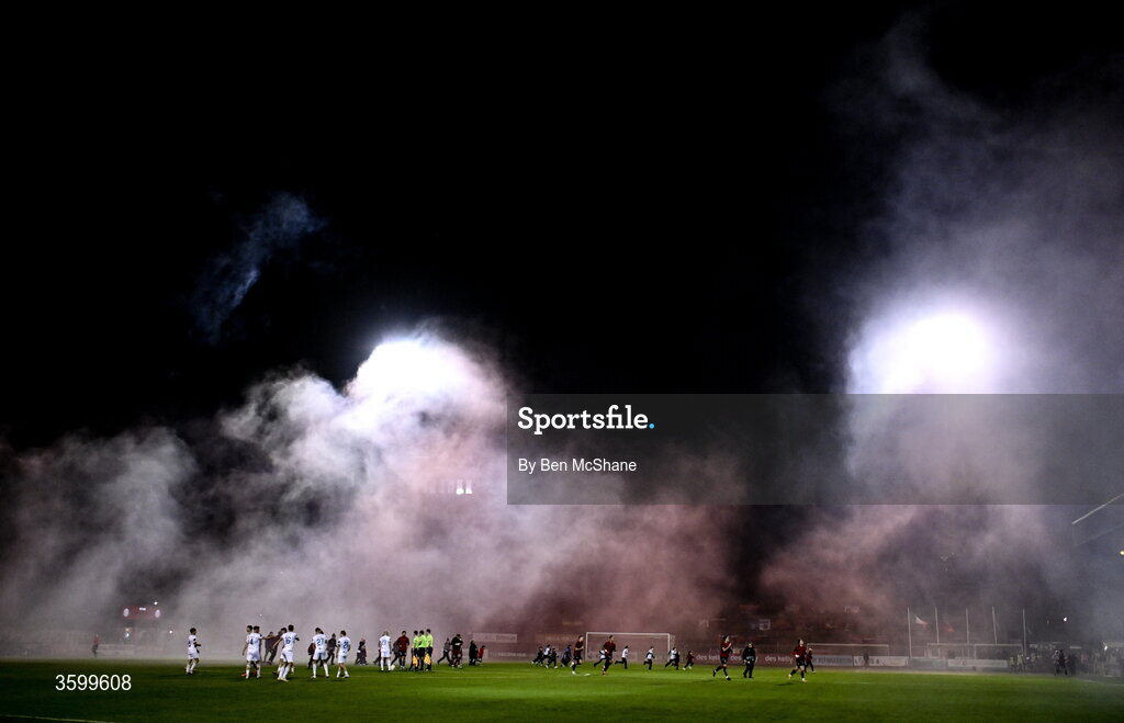 23 October 2026; Players and officials gather as they await the smoke from the pyrotechnics of both sets of supporters to clear before the SSE Airtricity Men's Premier Division match between Bohemians and Shelbourne at Dalymount Park in Dublin. Photo by Ben McShane/Sportsfile