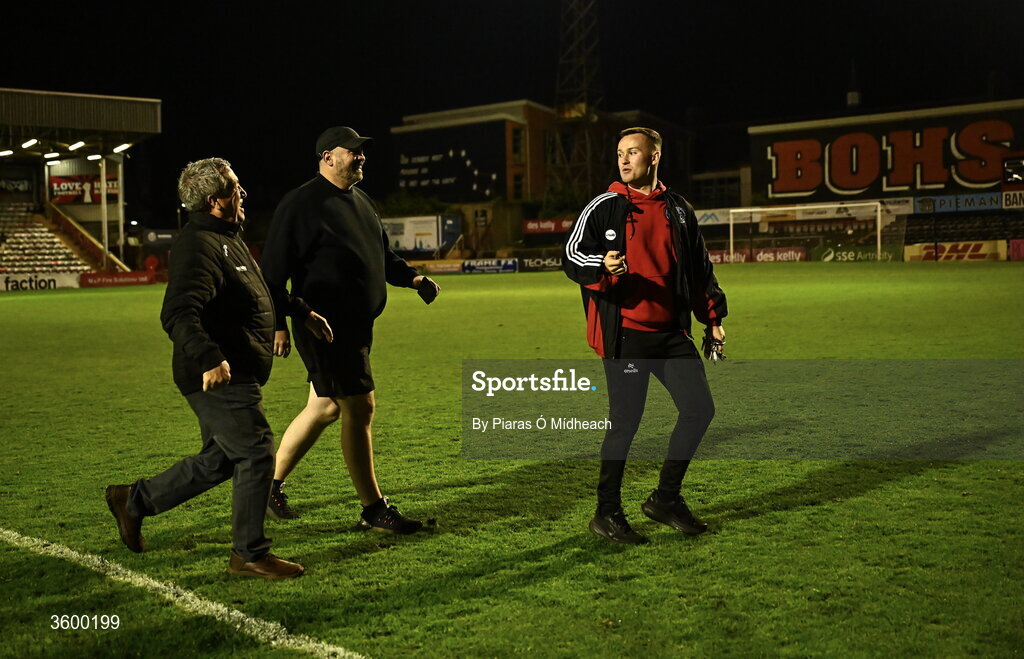 23 October 2026; Bohemians and Dalymount Park legend Dermot Cassin, left, Derek Sweetman, bar manager, centre, and Lee Grace, match day co-ordinator, make their way across the pitch to turn off the floodlights, with Cassin having the honour, after the last Friday night match under lights at Dalymount Park before upcoming demolition, after the SSE Airtricity Men's Premier Division match between Bohemians and Shelbourne at Dalymount Park in Dublin. Photo by Piaras Ó Mídheach/Sportsfile