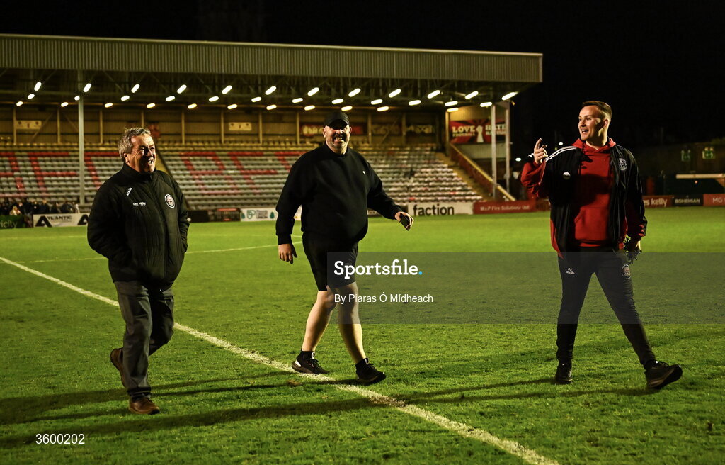 23 October 2026; Bohemians and Dalymount Park legend Dermot Cassin, left, Derek Sweetman, bar manager, centre, and Lee Grace, match day co-ordinator, make their way across the pitch to turn off the floodlights, with Cassin having the honour, after the last Friday night match under lights at Dalymount Park before upcoming demolition, after the SSE Airtricity Men's Premier Division match between Bohemians and Shelbourne at Dalymount Park in Dublin. Photo by Piaras Ó Mídheach/Sportsfile