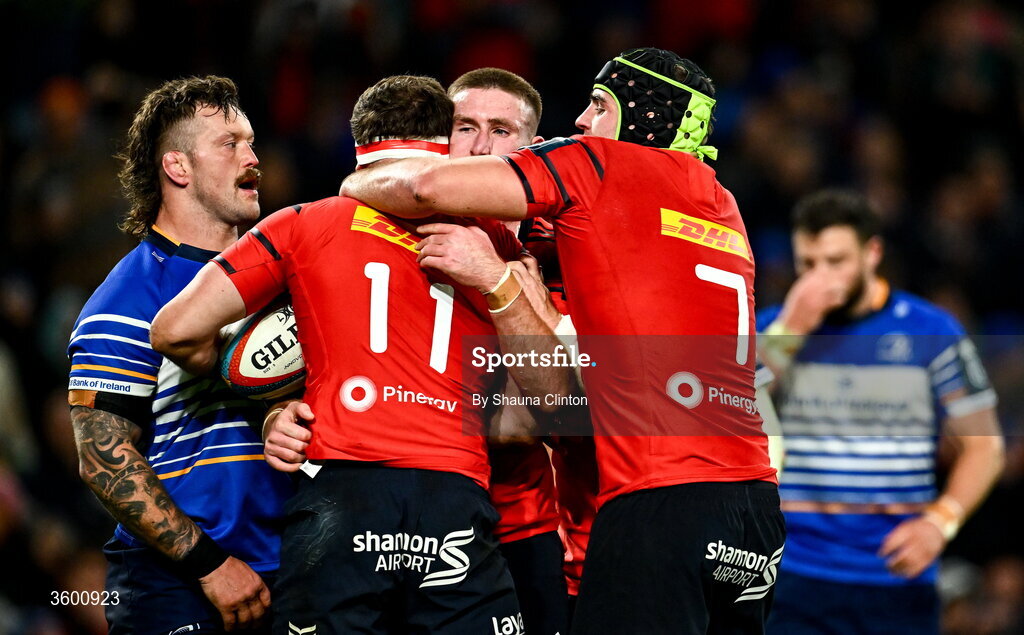 24 October 2026; Shane Daly, 11, is congratulated by Munster team-mates Ben O'Connor, centre, and Alex Kendellen after scoring their opening try during the United Rugby Championship match between Leinster and Munster at the Aviva Stadium in Dublin. Photo by Shauna Clinton/Sportsfile