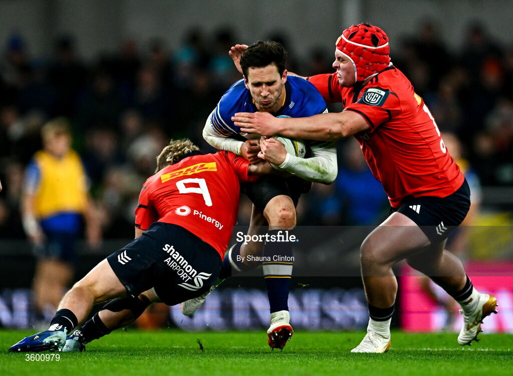 24 October 2026; Joey Carbery of Leinster is tackled by Craig Casey, left, and Marius van der Merwe of Munster during the United Rugby Championship match between Leinster and Munster at the Aviva Stadium in Dublin. Photo by Shauna Clinton/Sportsfile