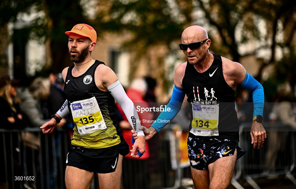 25 October 2026; Matthew Collins of Portmarnock AC, Dublin, left, and Ger Copeland of Dublin Bay Running AC, Dublin, during the 2026 Irish Life Dublin Marathon, as thousands of runners took to the streets of Dublin for the 45th running of the event. Photo by Shauna Clinton/Sportsfile
