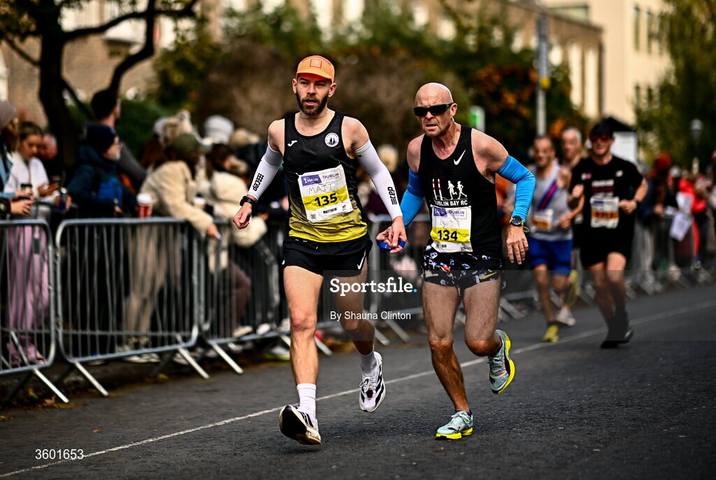 25 October 2026; Matthew Collins of Portmarnock AC, Dublin, left, and Ger Copeland of Dublin Bay Running AC, Dublin, during the 2026 Irish Life Dublin Marathon, as thousands of runners took to the streets of Dublin for the 45th running of the event. Photo by Shauna Clinton/Sportsfile