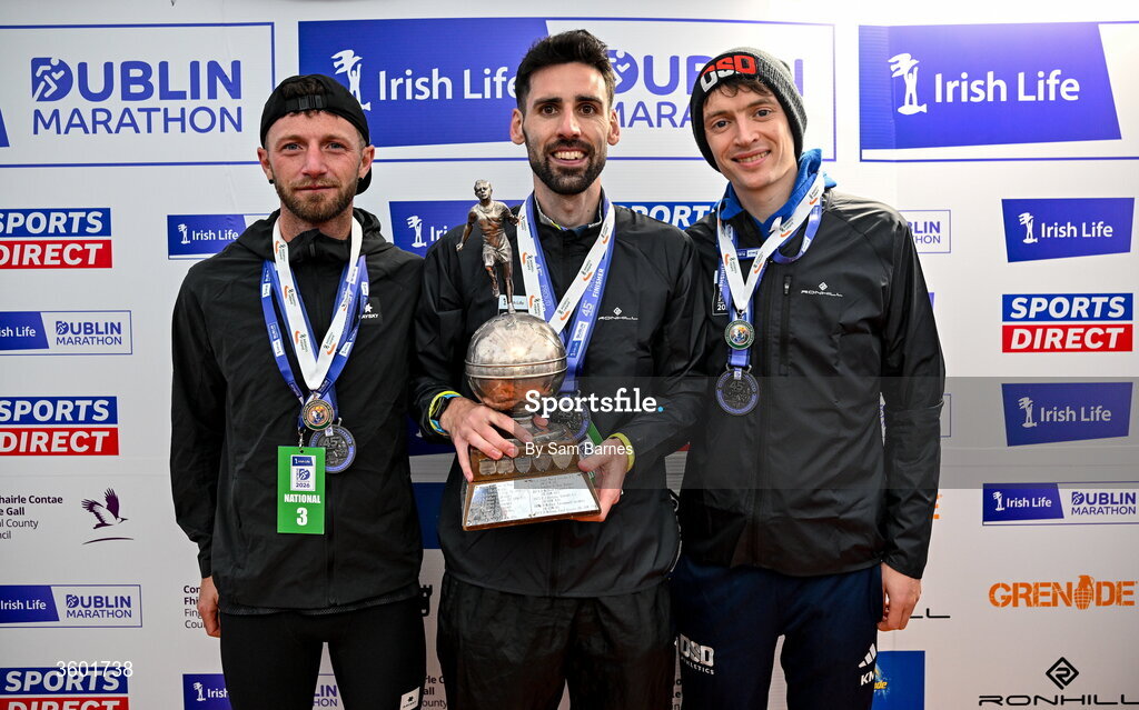 25 October 2026; Men's national championship top 3, from left, third place Stephen McAuley, winner Hugh Armstrong and second place Killian Mooney during the 2026 Irish Life Dublin Marathon, as thousands of runners took to the streets of Dublin for the 45th running of the event. Photo by Sam Barnes/Sportsfile