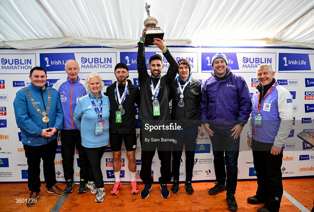 25 October 2026; Men's national championship top 3, from left, third place Stephen McAuley, winner Hugh Armstrong and second place Killian Mooney, with from left, Lord Mayor of Dublin Daryl Barron, Race Director Jim Aughney, Georgina Drumm, Athletics Ireland, Irish Life Chief Executive Declan Bolger and Michael Quinlin during the 2026 Irish Life Dublin Marathon, as thousands of runners took to the streets of Dublin for the 45th running of the event. Photo by Sam Barnes/Sportsfile