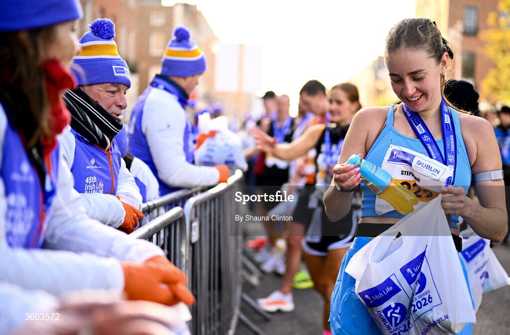 25 October 2026; Participants collect goody bags from volunteers after the 2026 Irish Life Dublin Marathon. Photo by Shauna Clinton/Sportsfile
