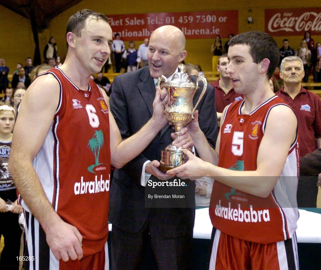 30 January 2005; Abrakebabra Tigers co-captains John Teahan and Kevin O'Donoghue, right, receive the cup from Tony Colgan, President of Basketball Ireland. National Cup, Senior Men's Final, Abrakebabra Tigers, Tralee v Roma St Vincent's, ESB Arena, Tallaght, Dublin. Picture credit; Brendan Moran / SPORTSFILE