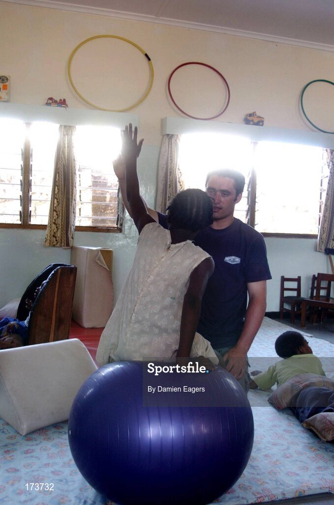 25 February 2005; Galway's Alan Kerins goes through a physiotherapy session with Brenda. Cheshire home for the physically challenged children, Mongu, Zambia. Picture credit; Damien Eagers / SPORTSFILE