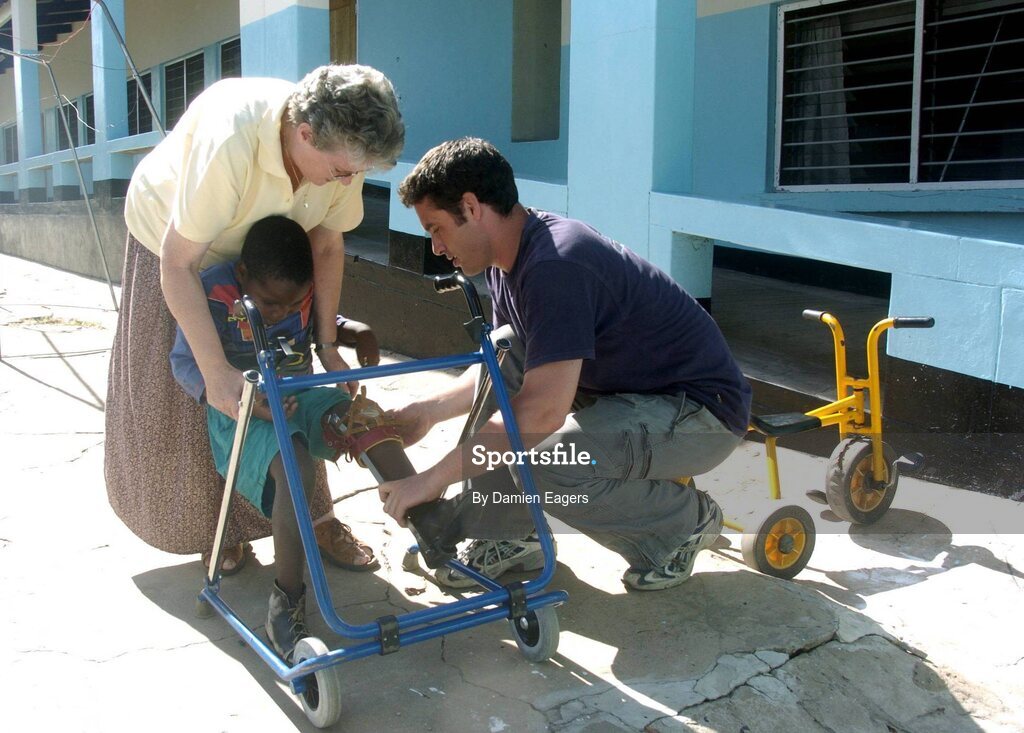 25 February 2005; Galway's Alan Kerins and Presentation sister Kathy Crawford help Lubasi. Cheshire home for the physically challenged children, Mongu, Zambia. Picture credit; Damien Eagers / SPORTSFILE