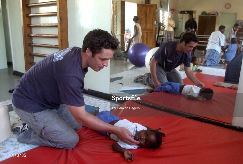 25 February 2005; Galway's Alan Kerins during a physiotherapy session with Mwiya. Cheshire home for the physically challenged children, Mongu, Zambia. Picture credit; Damien Eagers / SPORTSFILE