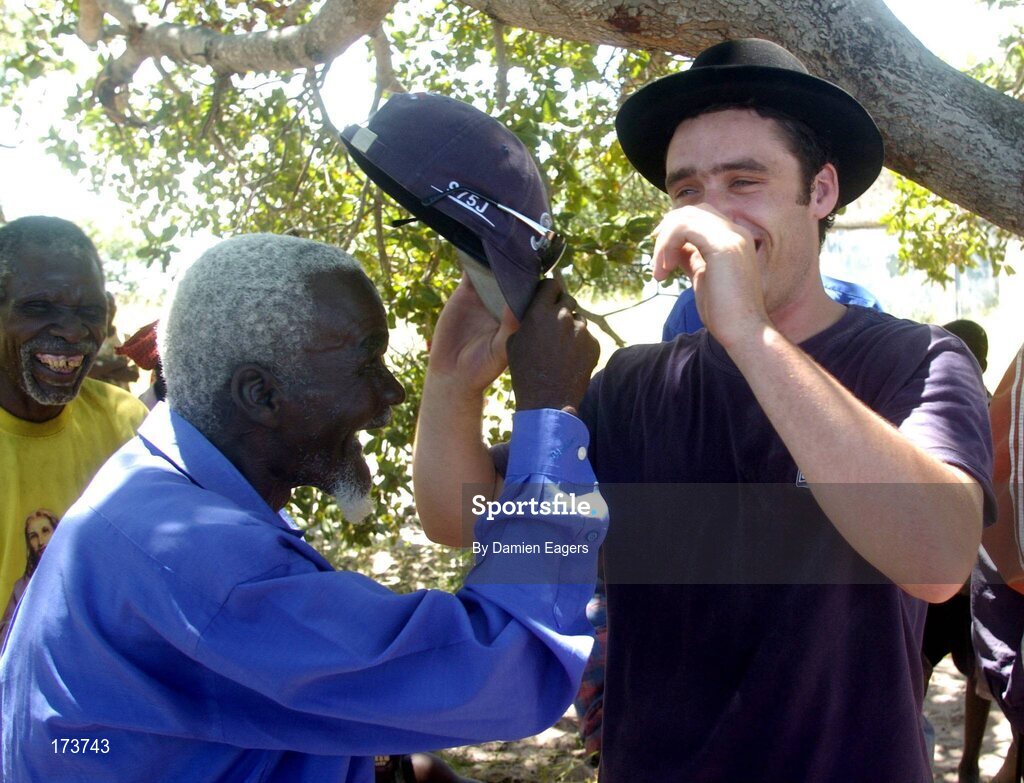 25 February 2005; Mr. Njamba, from Kataya, and Galway's Alan Kerins swap hats as bags of Mealie Meal arrive as part of the Presentation sisters Famine Relief project. Cheshire home for the physically challenged children, Mongu, Zambia. Picture credit; Damien Eagers / SPORTSFILE