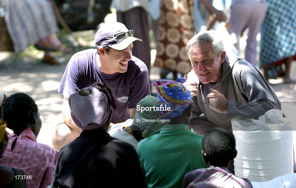 25 February 2005; Local people from Kalangu speak with Galway's Alan Kerins and Capuchin Priest James Connolly as bags of Mealie Meal arrive as part of the Presentation sisters Famine Relief project. Cheshire home for the physically challenged children, Mongu, Zambia. Picture credit; Damien Eagers / SPORTSFILE