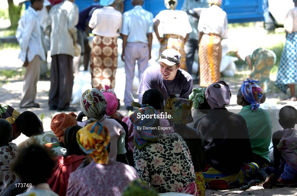 25 February 2005; Local people from Kalangu speak with Galway's Alan Kerins as bags of Mealie Meal arrive as part of the Presentation sisters Famine Relief project. Cheshire home for the physically challenged children, Mongu, Zambia. Picture credit; Damien Eagers / SPORTSFILE