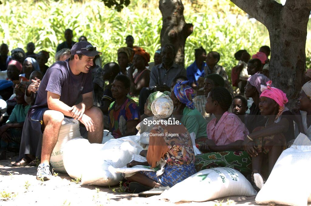 25 February 2005; People from Kalangu speak with Galway's Alan Kerins as bags of Mealie Meal arrive as part of the Presentation sisters Famine Relief project. Cheshire home for the physically challenged children, Mongu, Zambia. Picture credit; Damien Eagers / SPORTSFILE