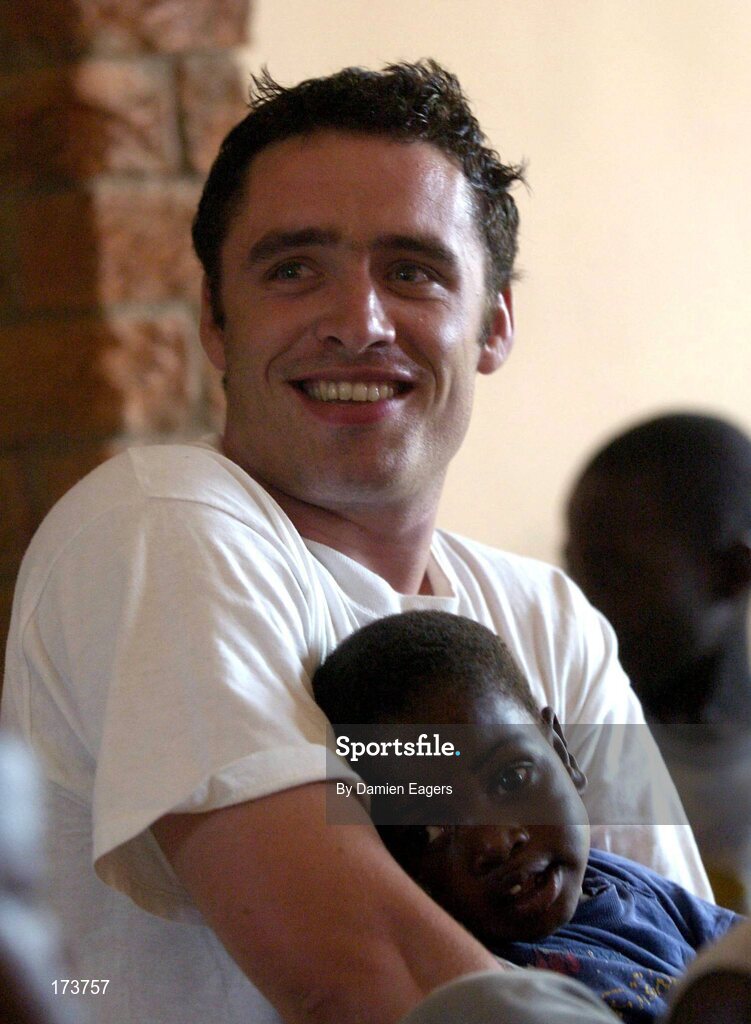 25 February 2005; Galway's Alan Kerins with Mwiya during mass. Cheshire home for the physically challenged children, Mongu, Zambia. Picture credit; Damien Eagers / SPORTSFILE